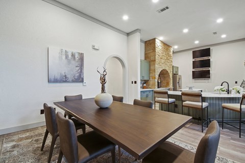 A dining room with a wooden table and chairs.