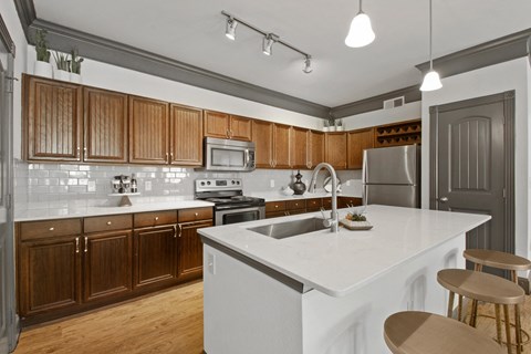 A kitchen with wooden cabinets and a white countertop.