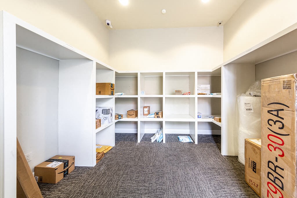 a room filled with boxes and shelves and white walls