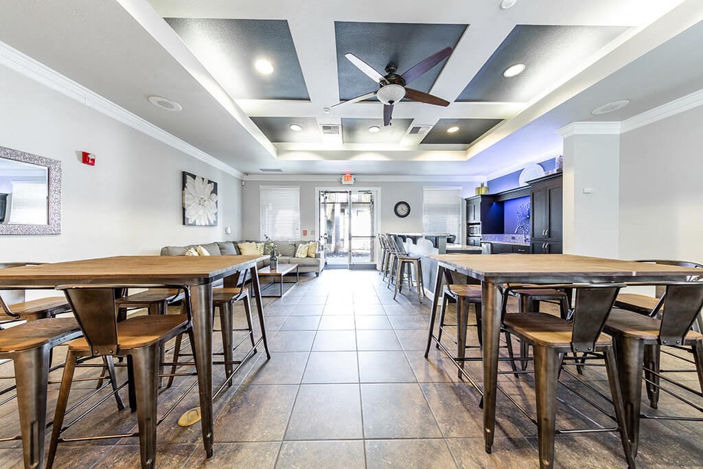 a dining room with tables and chairs and a ceiling fan