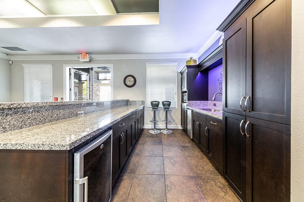 a kitchen with granite counter tops and wooden cabinets