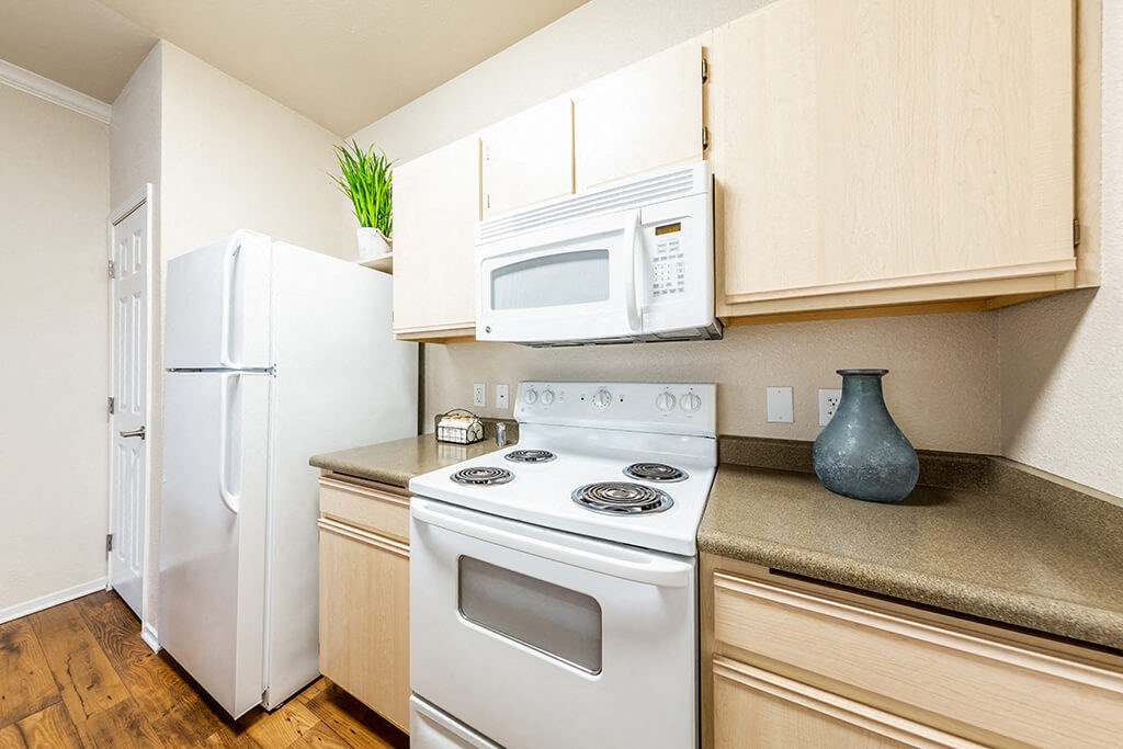 a kitchen with white appliances and a white refrigerator