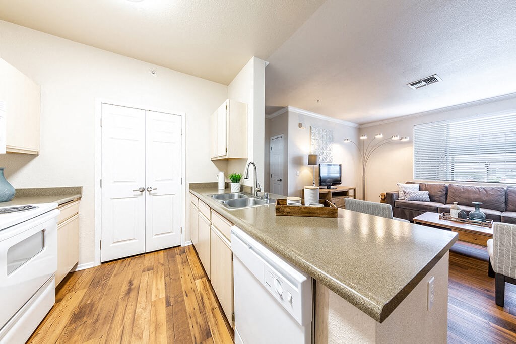 a kitchen with an island and a living room with a couch