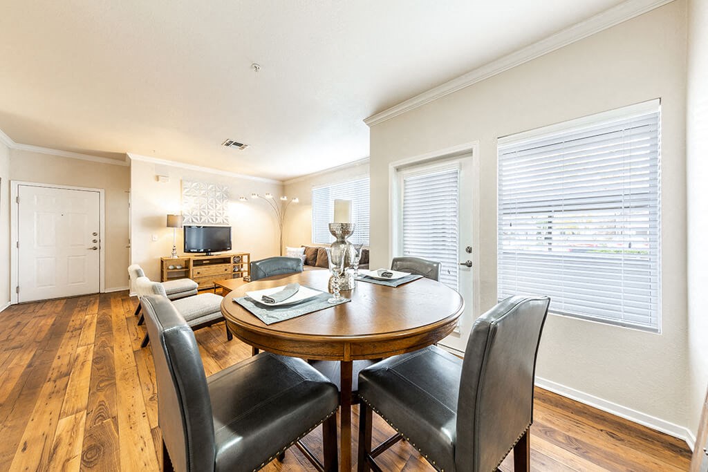 a dining room with a table and chairs and a living room