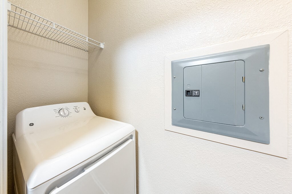 a laundry room with a washer and dryer and a door to the closet