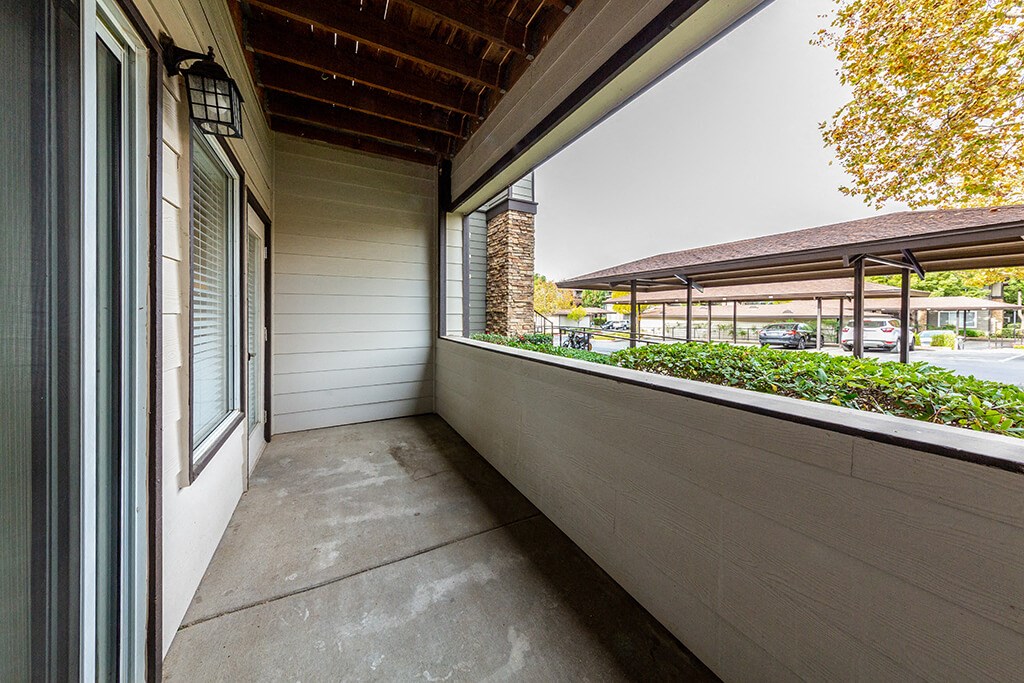 the porch of a home with a view of a parking lot