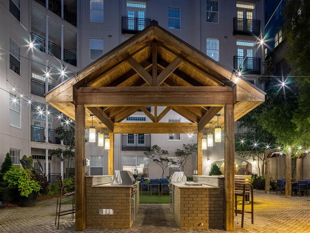 a large wooden structure in an apartment complex at night