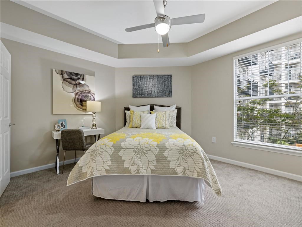 a bedroom with a bed and a ceiling fan