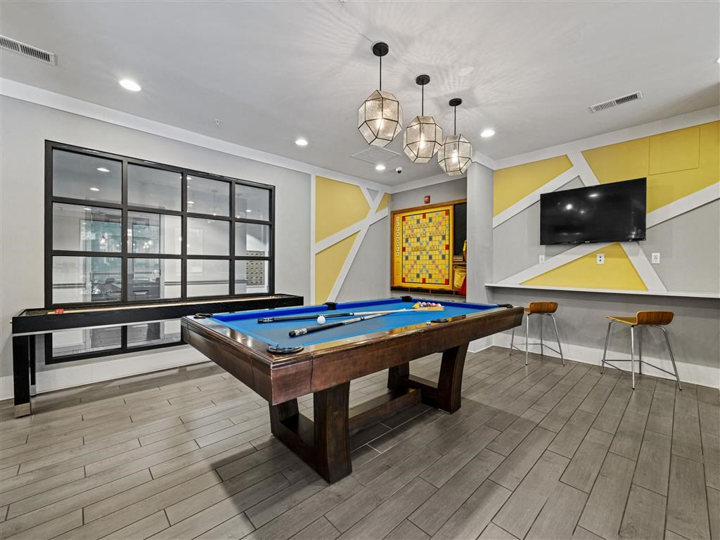 a game room with a pool table and a television