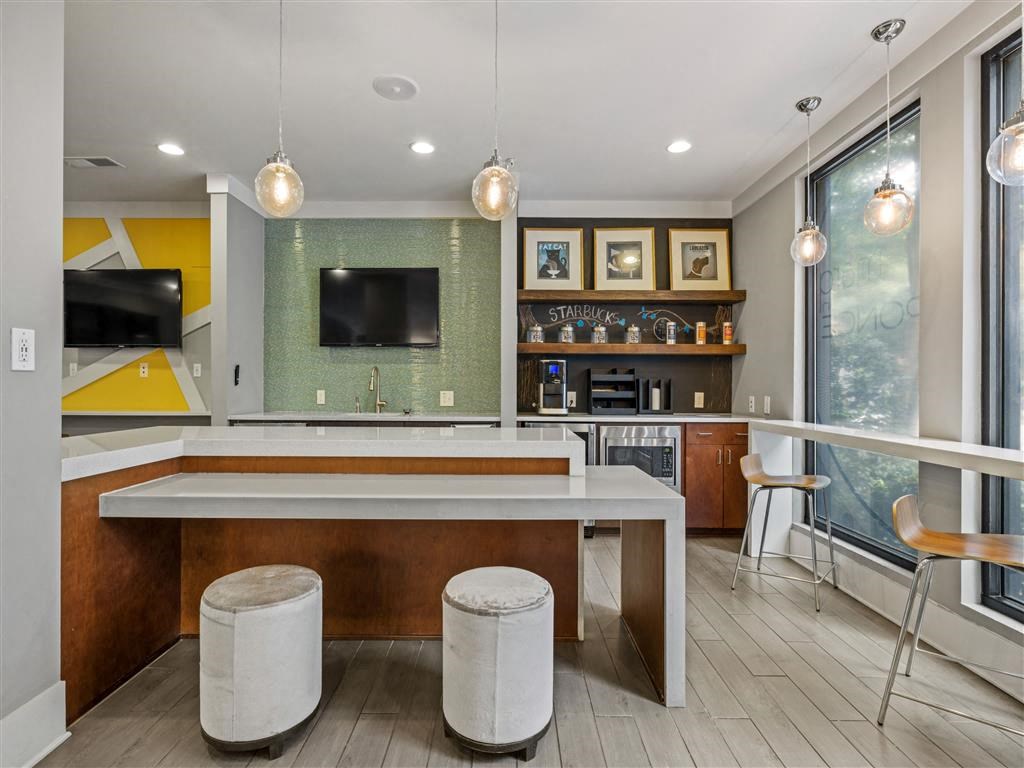 a large kitchen with a bar and a television