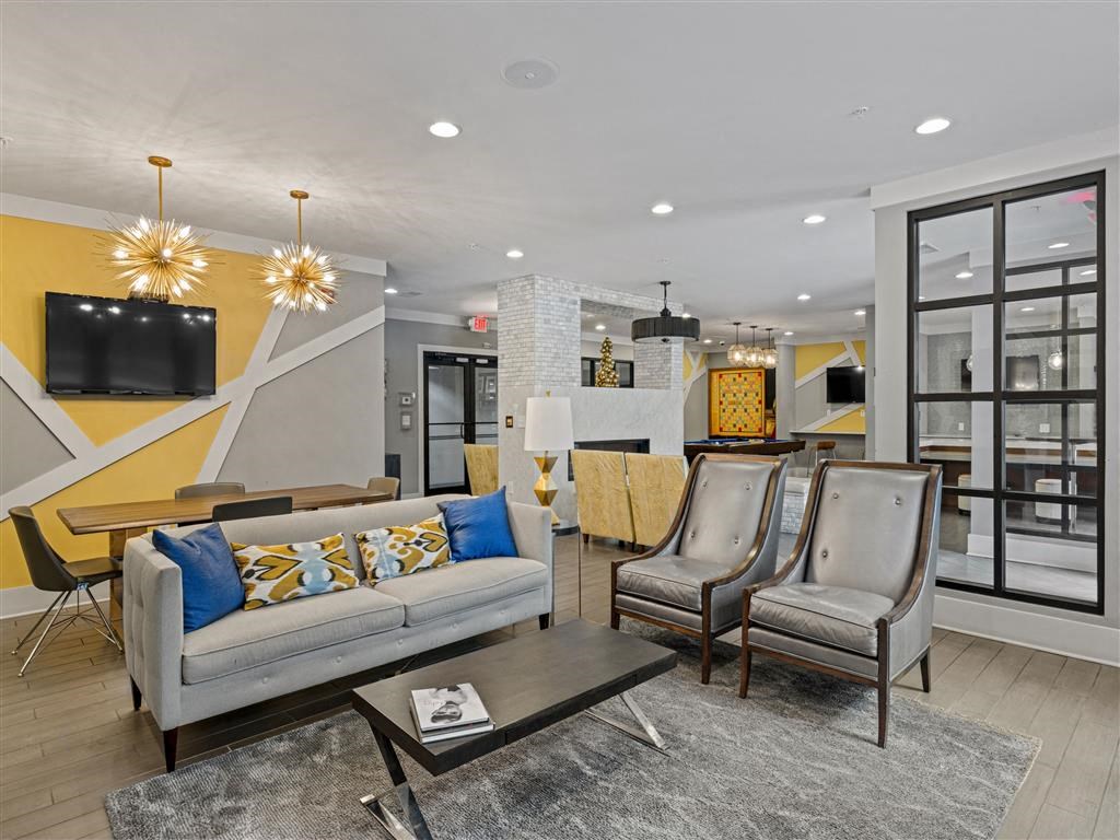 a living room with couches and chairs and a table