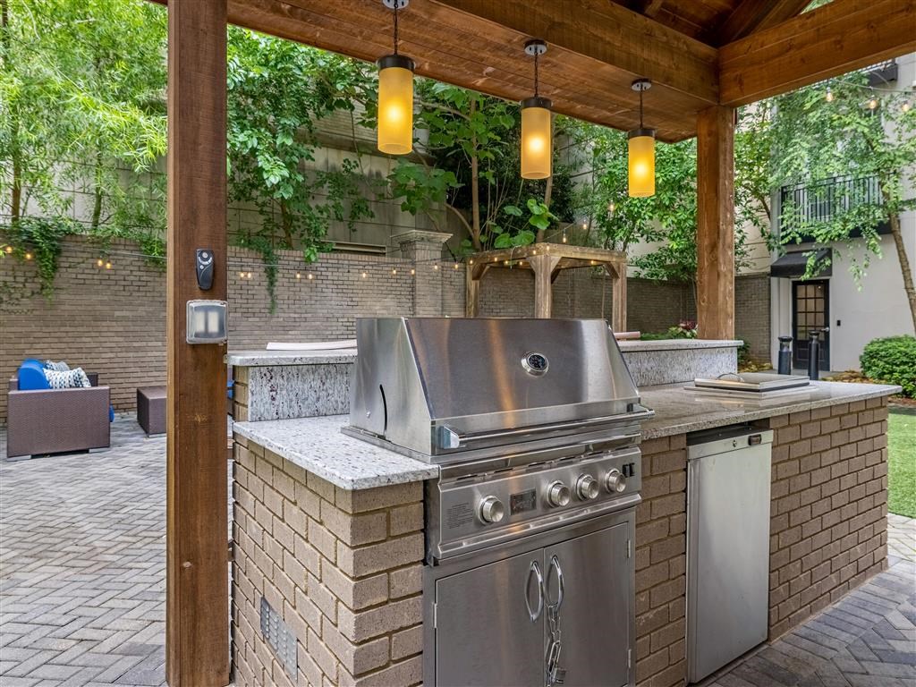 a stainless steel outdoor kitchen with a grill