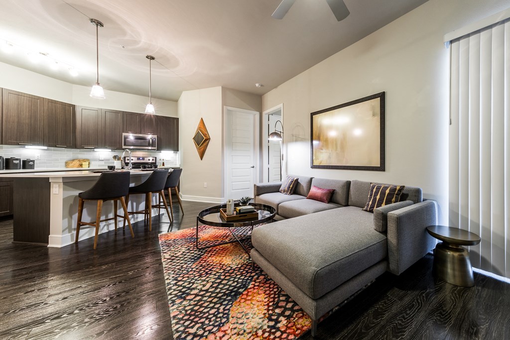 a living room and kitchen with a couch and a table