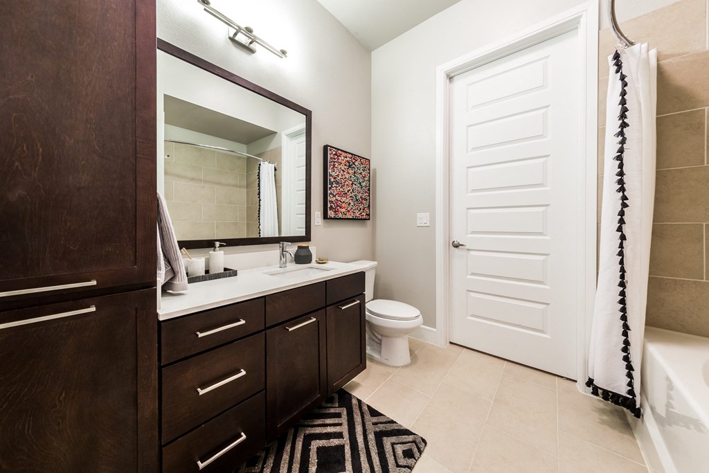a bathroom with a toilet and a sink and a mirror