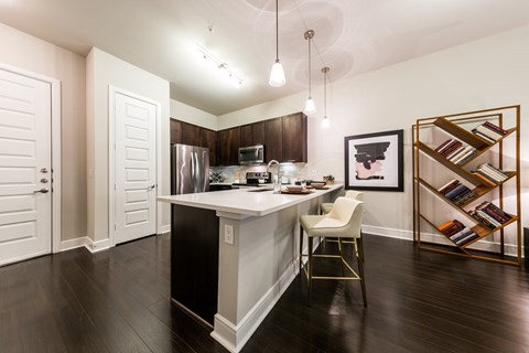 a kitchen with a white counter top and a refrigerator