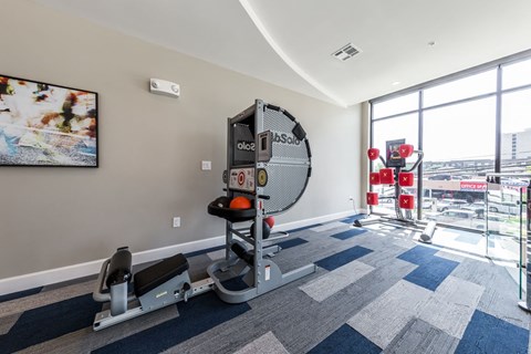 a gym with a view of the city at the district flats apartments