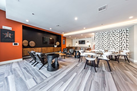 a dining room with tables and chairs and a tv