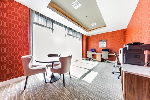 a conference room with a table and chairs and a printer