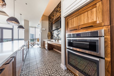a kitchen with stainless steel appliances and wooden cabinets