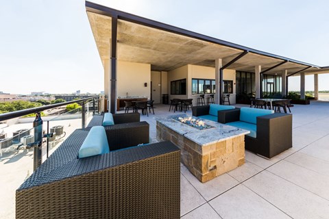 a large patio with furniture and a fire pit