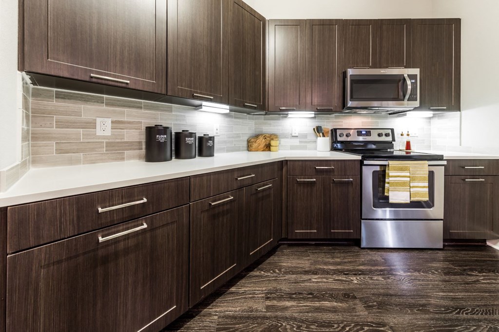 a kitchen with wooden cabinets and stainless steel appliances
