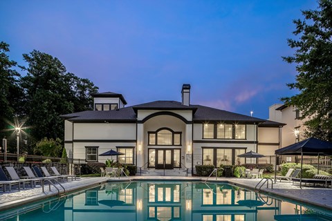 A large house with a pool in front.