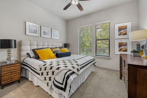 a bedroom with a bed and a ceiling fan