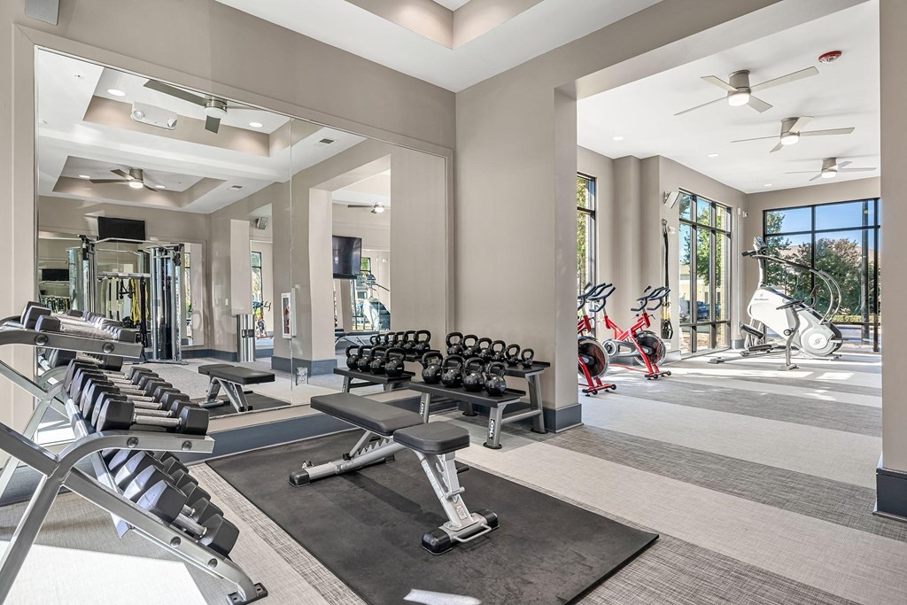 a gym with cardio machines and other exercise equipment at the estates estates