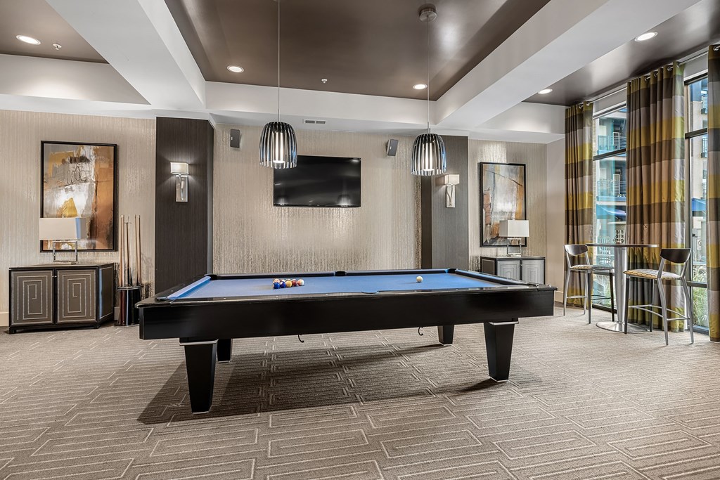 a pool table in a lobby with a tv