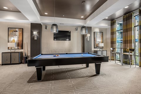 a pool table in a lobby with a tv
