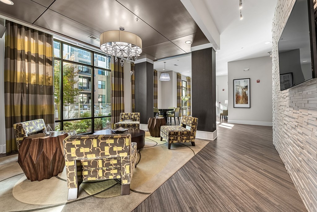 a lobby with couches and chairs and a large window