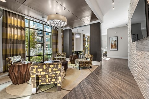 a lobby with couches and chairs and a large window