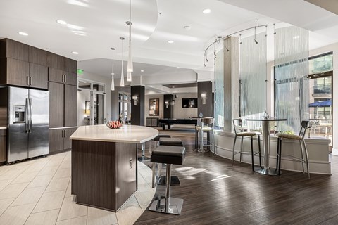 a large kitchen with a center island and stainless steel appliances