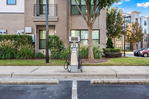 a gas pump on a sidewalk in front of an apartment building