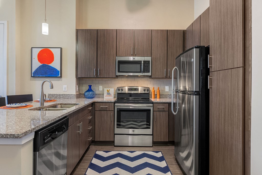 kitchen with stainless steel appliances and granite counter tops and wooden cabinets