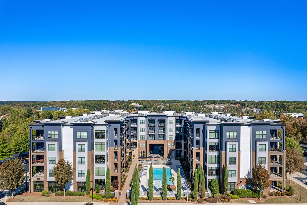 an aerial view of an apartment building with a swimming pool