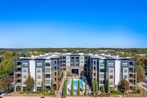 an aerial view of an apartment building with a swimming pool