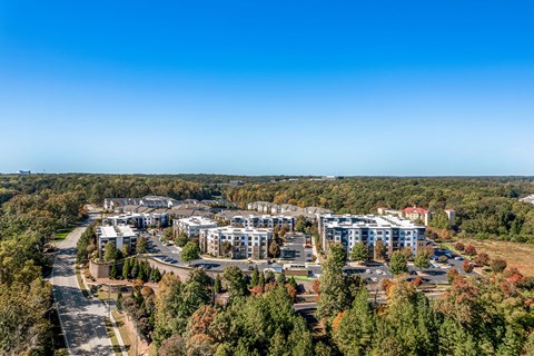 an aerial view of apartment buildings in a city with trees