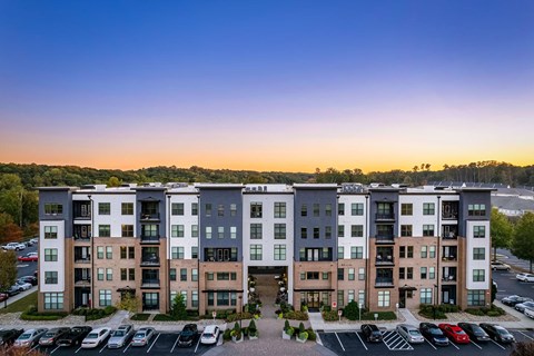 an aerial view of an apartment building at dusk