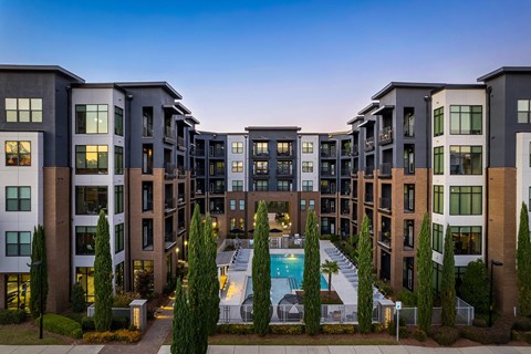 an aerial view of an apartment building with a swimming pool