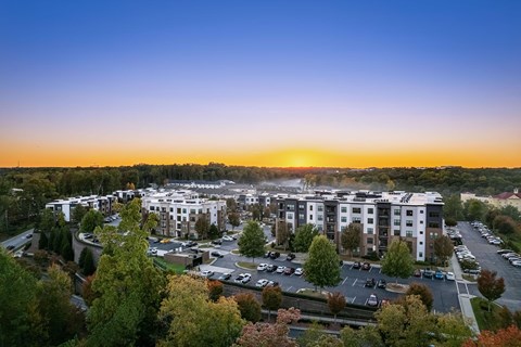 an aerial view of an apartment complex at sunset