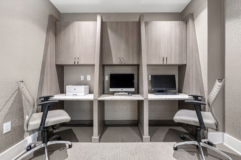 a treatment room with two computers and two chairs