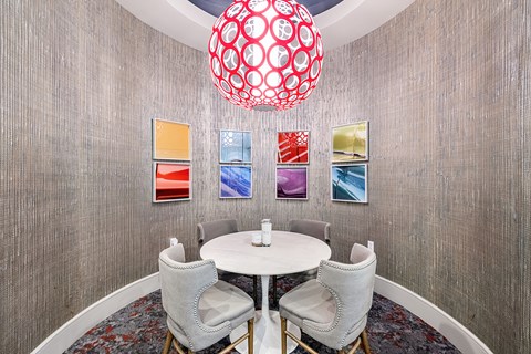 a dining room with a round table and chairs
