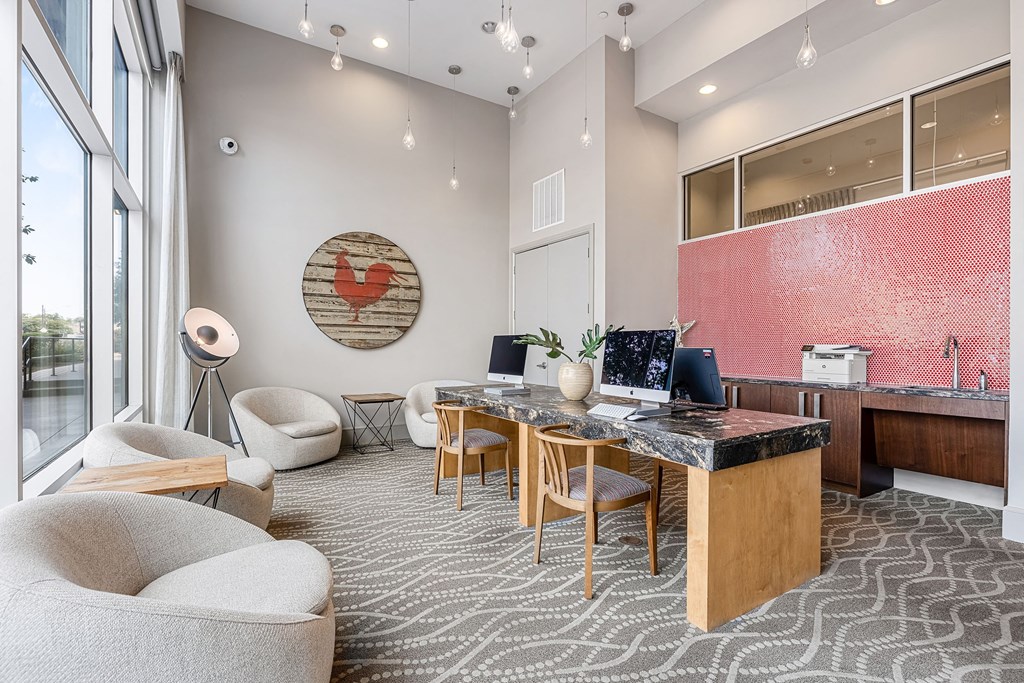 a conference room with a desk and chairs and a large window