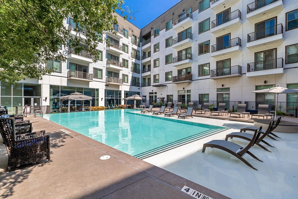 a swimming pool in front of an apartment building