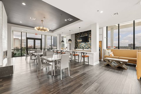 A modern dining room with a large table and chairs.