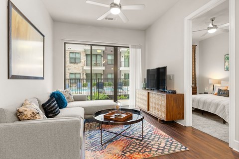 A living room with a grey couch and a coffee table.