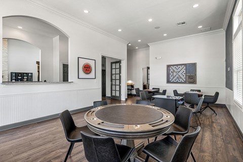 A dining room with a round table and chairs.