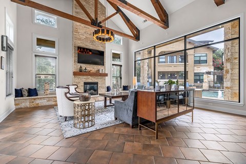 A modern living room with a fireplace and a large window.
