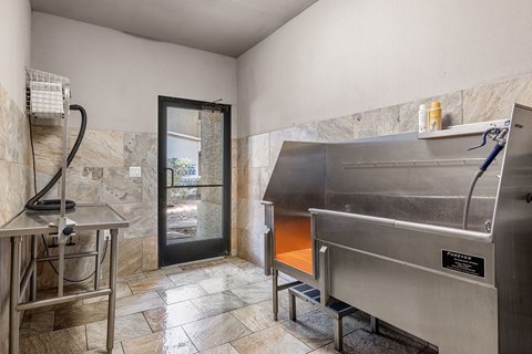 A kitchen with a stainless steel oven and a marble floor.
